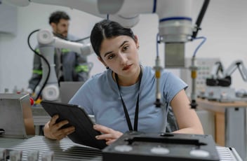 Hispanic engineer woman working on AI technology in robotics electronics engineering laboratory