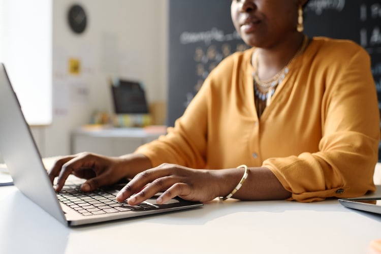 women writing statement of purpose for graduate degree at desk