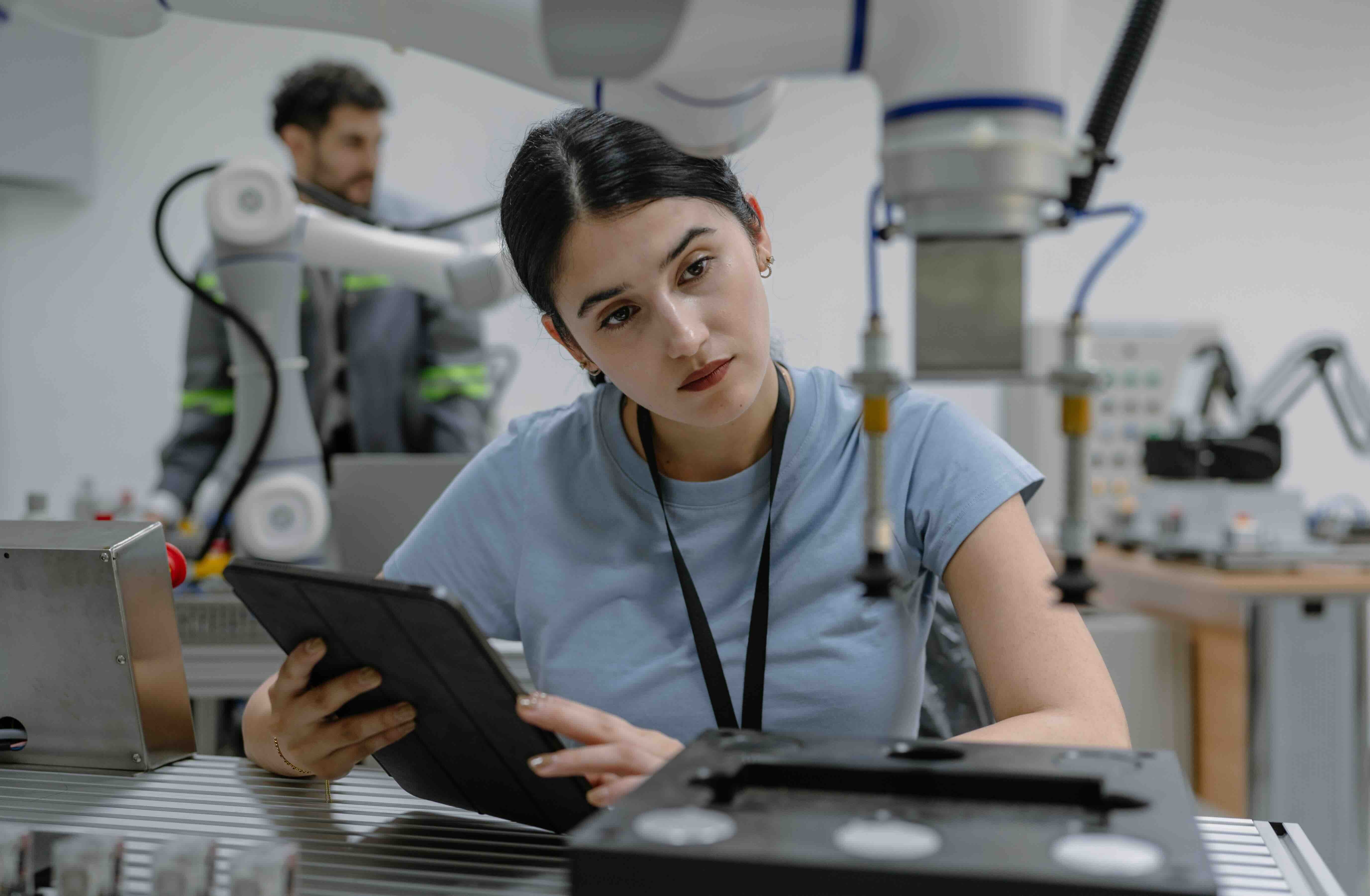Hispanic engineer woman working on AI technology in robotics electronics engineering laboratory